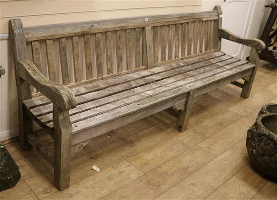 A large wooden garden bench W.240cm.